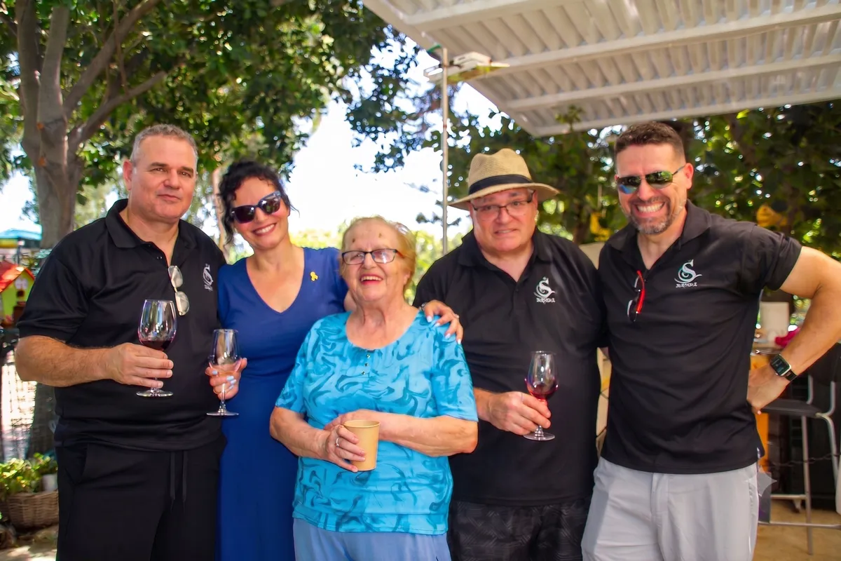 The Sodot Winery family raising a toast together in the yard